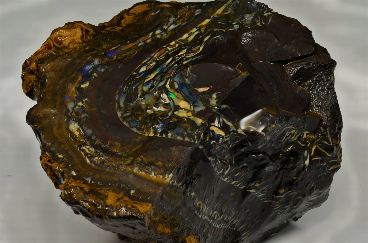 An interesting concave face freeform shaped good boulder opal from the opalfields of Winton in Queensland